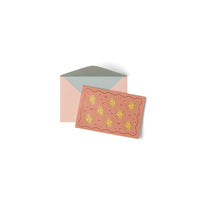 Card with sun design and matching envelope on a white background
